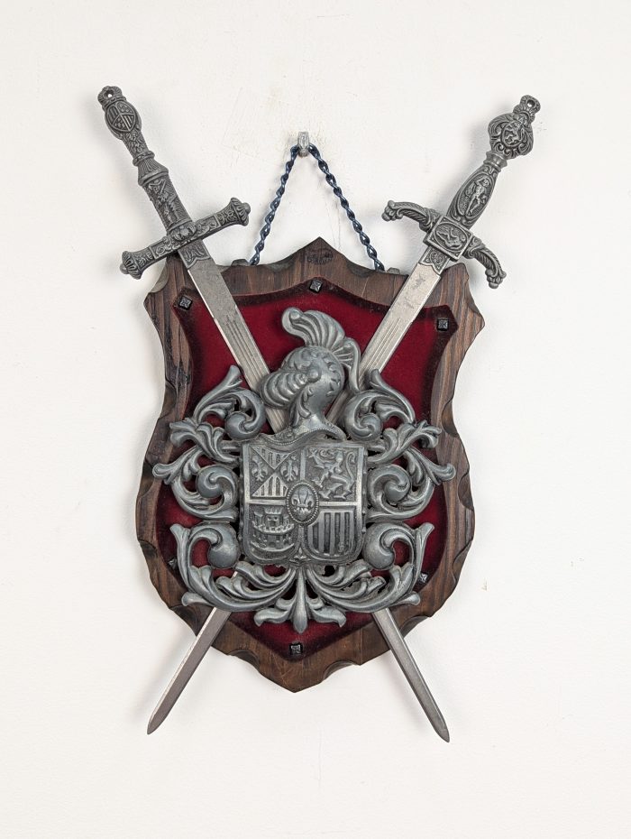 Decorative wall panel with two swords and a heraldic emblem